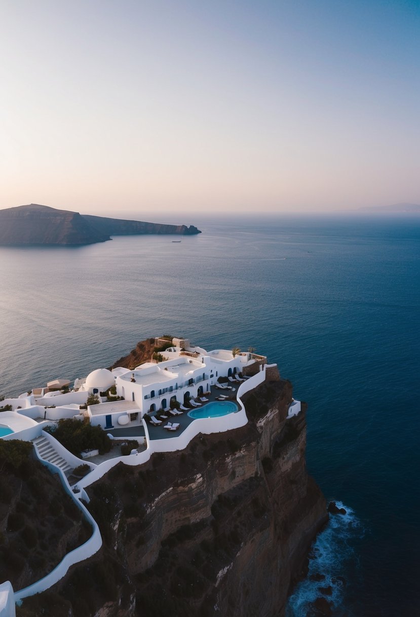 Aerial view of Canaves Oia Hotel, perched on the cliffs of Santorini overlooking the Aegean Sea